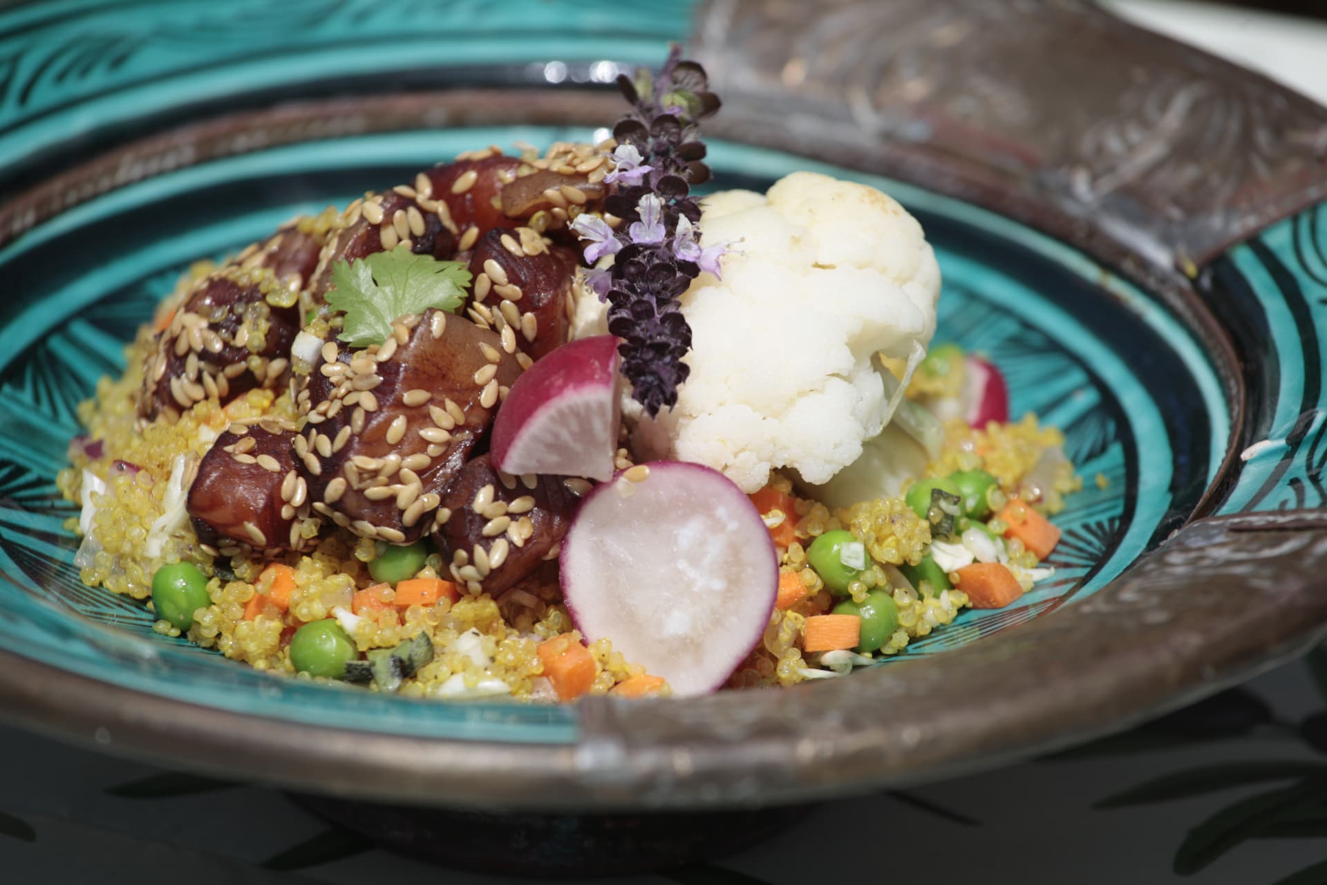 Plant-based protein poke bowl with quinoa, peas, sesame-crusted tofu and pickled radish