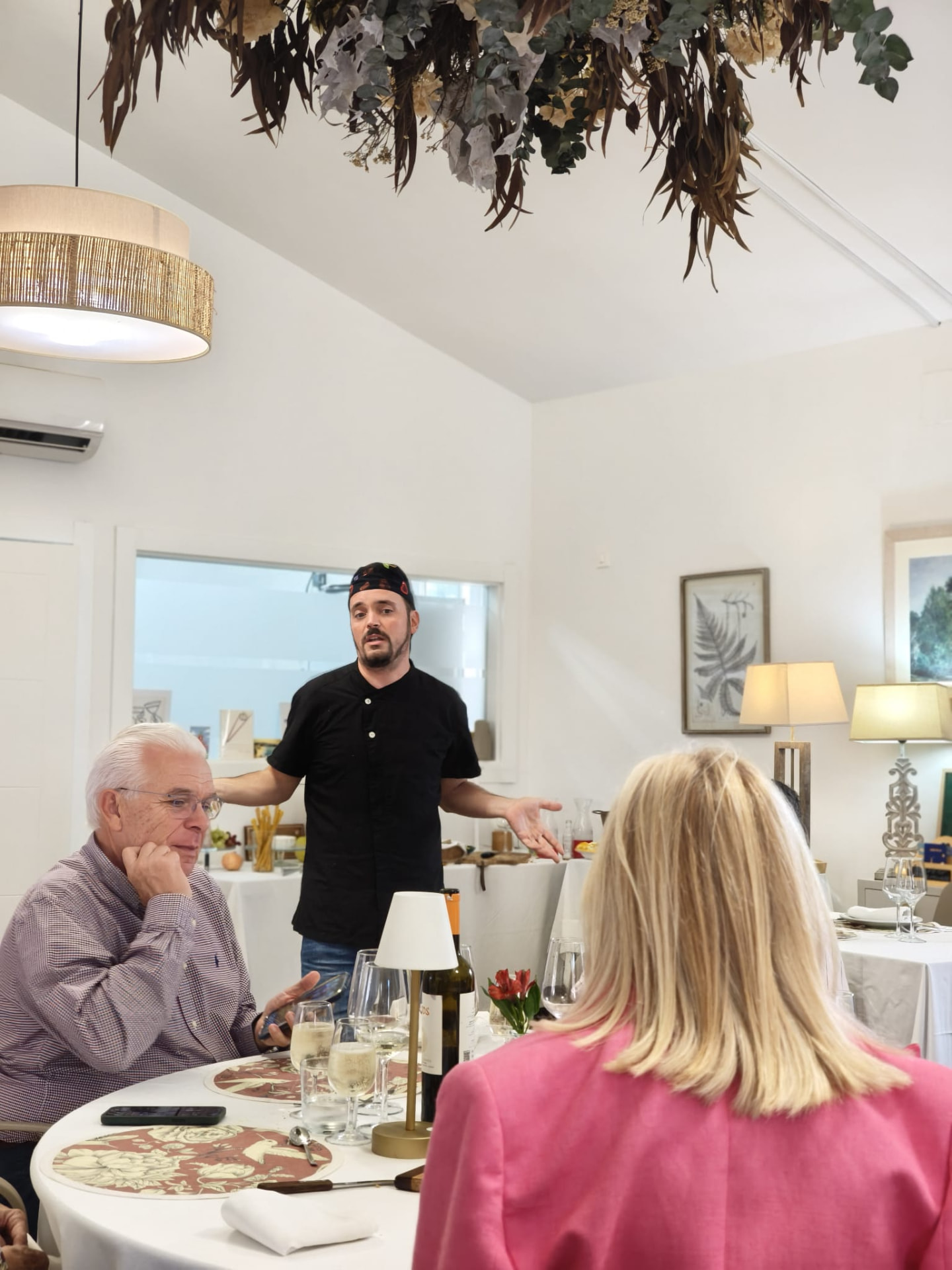 Chef presenting a plant-based private dinner to guests